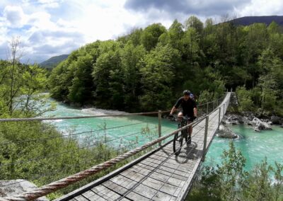 Mountainbiker over hangbrug in Slovenië